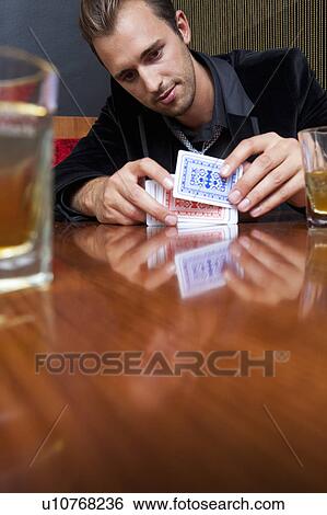 Man shuffling cards in bar View Large Photo Image Stock Photograph - Man shuffling cards in bar. Fotosearch