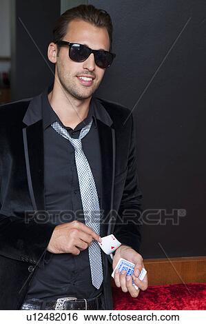 Man slipping cards up his sleeve View Large Photo Image Stock Photograph - Man slipping cards up his sleeve. Fotosearch