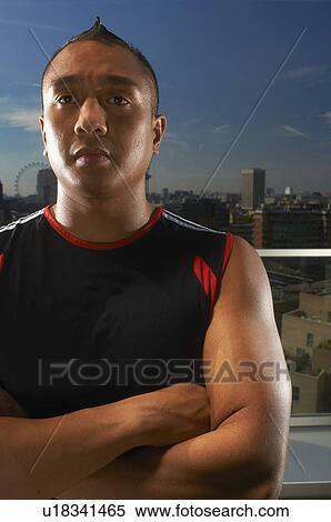 Man standing on urban rooftop View Large Photo Image Stock Photography - Man standing on urban rooftop. Fotosearch