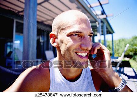 Stock Photo - Man talking on cell phone outdoors. Fotosearch