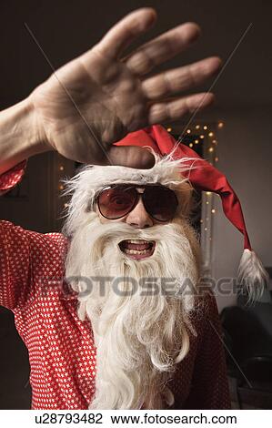 Man wearing Santa Claus hat and beard View Large Photo Image Stock Image - Man wearing Santa Claus hat and beard. Fotosearch