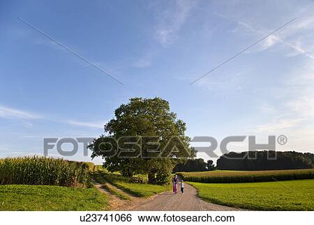 Mother and children on gravel road View Large Photo Image Stock Photograph - Mother and children on gravel road. Fotosearch