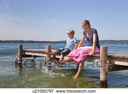 Mother and daughter dipping feet in lake View Large Photo Image Stock Photo - Mother and daughter dipping feet in lake. Fotosearch