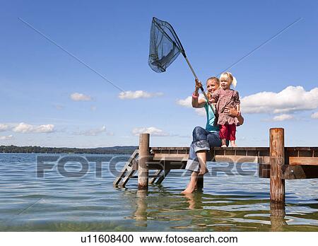 Mother and daughter fishing with net View Large Photo Image Stock Image - Mother and daughter fishing with net. Fotosearch