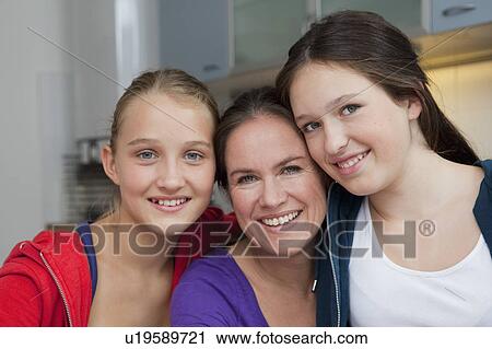 Mother and daughters smiling together View Large Photo Image Stock Image - Mother and daughters smiling together. Fotosearch