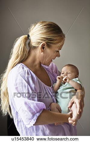 Mother cradling infant View Large Photo Image Stock Image - Mother cradling infant. Fotosearch