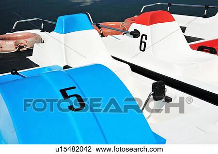 Numbered paddleboats docked by lake View Large Photo Image Stock Image - Numbered paddleboats docked by lake. Fotosearch