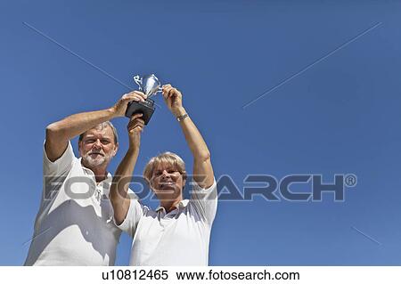 Older couple cheering with trophy View Large Photo Image Stock Photography - Older couple cheering with trophy. Fotosearch