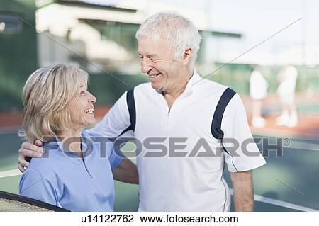 Older couple hugging on tennis court View Large Photo Image Stock Image - Older couple hugging on tennis court. Fotosearch