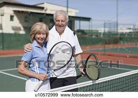 Older couple hugging on tennis court View Large Photo Image Stock Photo - Older couple hugging on tennis court. Fotosearch