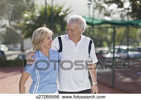 Older couple walking together View Large Photo Image Stock Photograph - Older couple walking together. Fotosearch