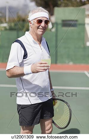Older man drinking lemonade on court View Large Photo Image Stock Photo - Older man drinking lemonade on court. Fotosearch