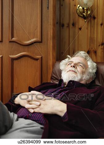 Stock Photo - Older man relaxing in armchair. Fotosearch