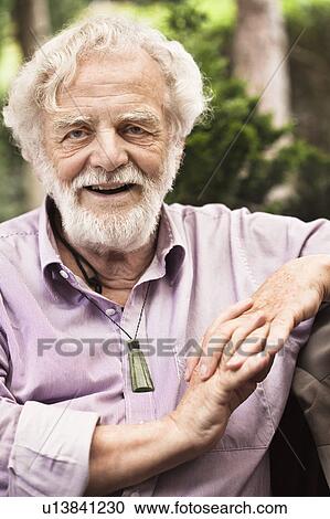 Older man sitting with hands folded View Large Photo Image Stock Image - Older man sitting with hands folded. Fotosearch