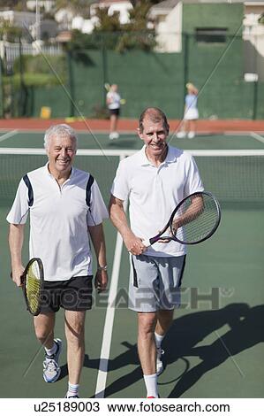 Older men walking on tennis court View Large Photo Image Stock Image - Older men walking on tennis court. Fotosearch