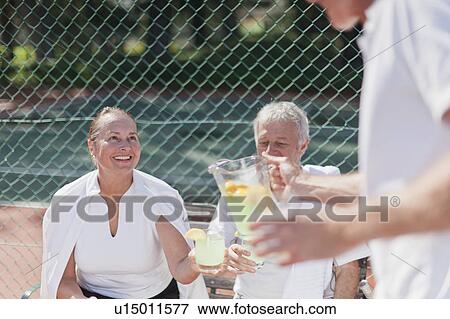 Older people having lemonade outdoors View Large Photo Image Stock Photo - Older people having lemonade outdoors. Fotosearch