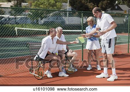 Stock Photo - Older people having lemonade outdoors. Fotosearch