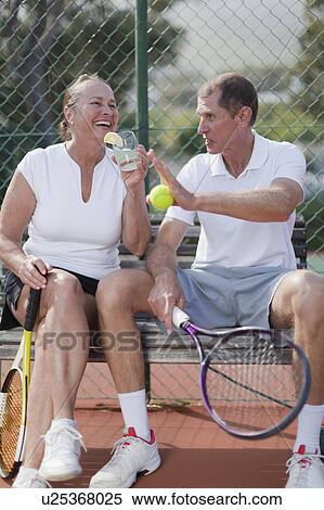 Stock Photography - Older people having lemonade outdoors. Fotosearch
