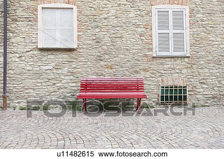 Red bench on cobbled village street View Large Photo Image Stock Photography - Red bench on cobbled village street. Fotosearch
