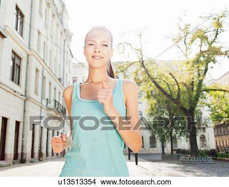 Runner jogging on city street View Large Photo Image Picture - Runner jogging on city street. Fotosearch