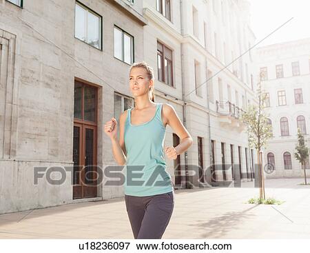 Runner jogging on city street View Large Photo Image Stock Photo - Runner jogging on city street. Fotosearch