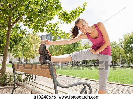 Runner stretching in park View Large Photo Image Stock Photography - Runner stretching in park. Fotosearch