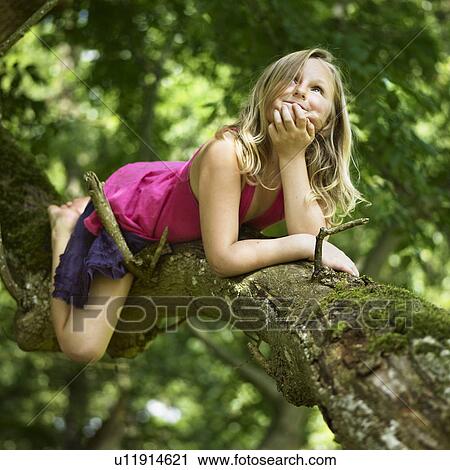Smiling girl climbing tree View Large Photo Image Stock Image - Smiling girl climbing tree. Fotosearch