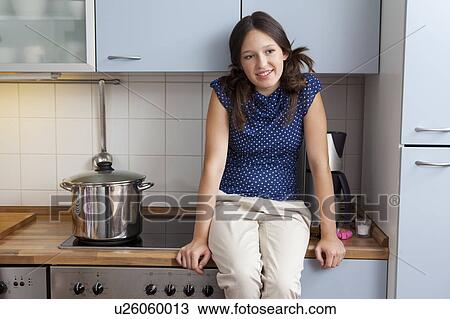 Smiling girl cooking in kitchen View Large Photo Image Stock Image - Smiling girl cooking in kitchen. Fotosearch