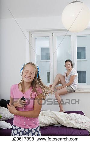 Smiling girl dancing to mp3 player View Large Photo Image Stock Photo - Smiling girl dancing to mp3 player. Fotosearch