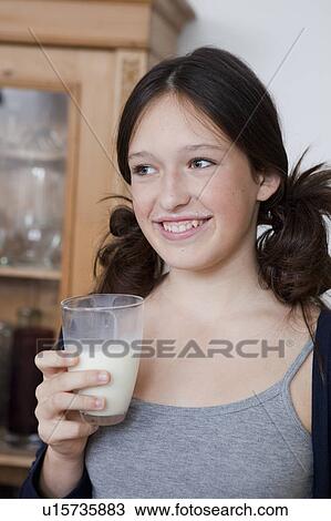 Smiling girl drinking milk in kitchen View Large Photo Image Stock Image - Smiling girl drinking milk in kitchen. Fotosearch