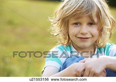 Smiling girl sitting outdoors View Large Photo Image Stock Photograph - Smiling girl sitting outdoors. Fotosearch