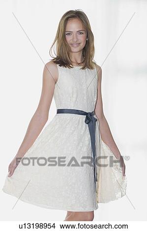 Picture - Smiling girl wearing elegant dress. Fotosearch