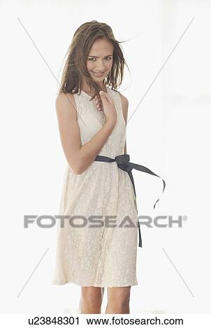 Stock Image - Smiling girl wearing elegant dress. Fotosearch