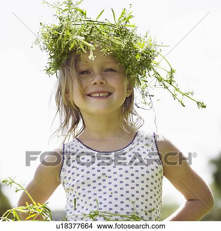 Smiling girl wearing grassy crown View Large Photo Image Picture - Smiling girl wearing grassy crown. Fotosearch