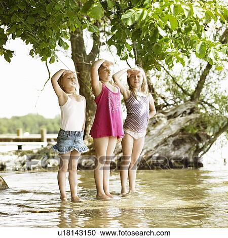 Smiling girls playing in lake View Large Photo Image Stock Image - Smiling girls playing in lake. Fotosearch