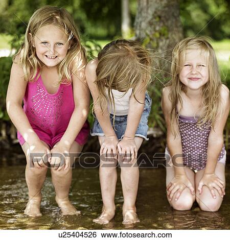 Smiling girls playing in lake View Large Photo Image Stock Photograph - Smiling girls playing in lake. Fotosearch