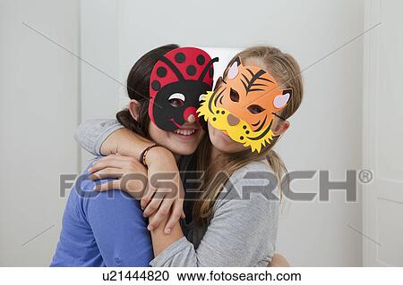 Smiling girls wearing colorful masks View Large Photo Image Stock Image - Smiling girls wearing colorful masks. Fotosearch
