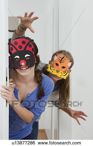 Smiling girls wearing colorful masks View Large Photo Image Stock Photograph - Smiling girls wearing colorful masks. Fotosearch