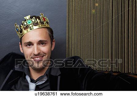 Smiling man wearing plastic crown View Large Photo Image Stock Image - Smiling man wearing plastic crown. Fotosearch