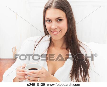 Smiling woman drinking cup of coffee View Large Photo Image Stock Photo - Smiling woman drinking cup of coffee. Fotosearch