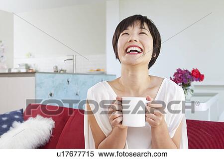 Smiling woman drinking cup of coffee View Large Photo Image Stock Photography - Smiling woman drinking cup of coffee. Fotosearch