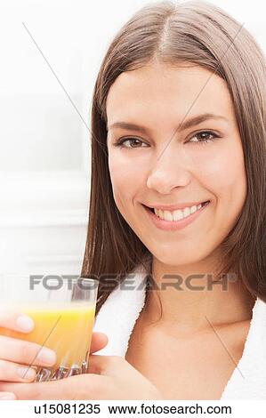 Smiling woman drinking orange juice View Large Photo Image Stock Photography - Smiling woman drinking orange juice. Fotosearch