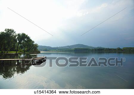 Still lake under blue sky View Large Photo Image Picture - Still lake under blue sky. Fotosearch