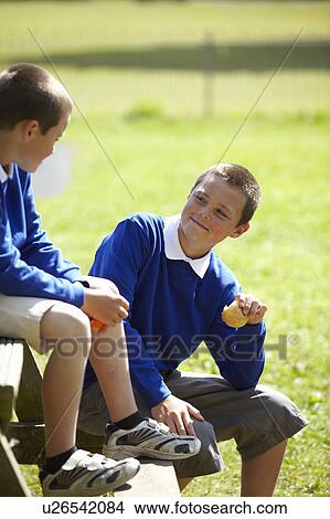 Students eating together outdoors View Large Photo Image Picture - Students eating together outdoors. Fotosearch