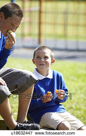 Students eating together outdoors View Large Photo Image Stock Photo - Students eating together outdoors. Fotosearch