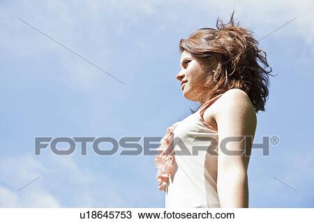 Teenage girl against blue sky View Large Photo Image Stock Image - Teenage girl against blue sky. Fotosearch