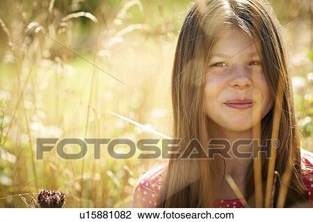 Teenage girl smiling in tall grass View Large Photo Image Stock Image - Teenage girl smiling in tall grass. Fotosearch