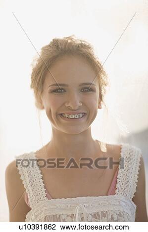 Teenage girl smiling to reveal braces View Large Photo Image Stock Image - Teenage girl smiling to reveal braces. Fotosearch
