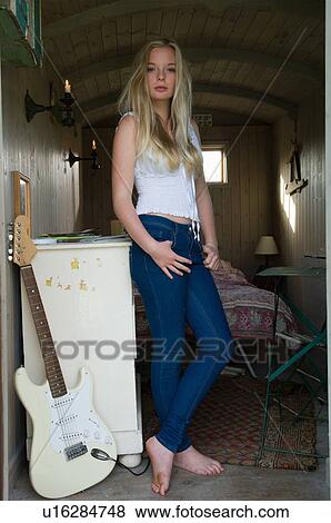 Teenage girl standing in bedroom View Large Photo Image Stock Photo - Teenage girl standing in bedroom. Fotosearch