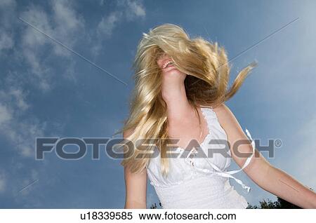 Teenage girl tossing her hair outdoors View Large Photo Image Stock Photography - Teenage girl tossing her hair outdoors. Fotosearch